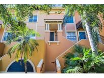 Attractive exterior of a multi-story building with balconies and lush tropical landscaping at 100 4Th S Ave # 132, St Petersburg, FL 33701