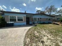 Charming single-story home with blue brick exterior and inviting front walkway at 1105 Connecticut Rd, Tarpon Springs, FL 34689