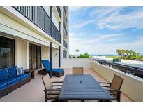 Inviting balcony with stylish seating offering partial ocean views and outdoor dining space at 1460 Gulf Blvd # 108, Clearwater, FL 33767