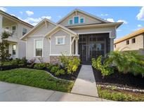 Charming home featuring a screened porch and beautifully landscaped front yard at 28853 Seedling St, Wesley Chapel, FL 33543