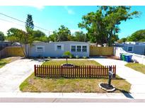 Charming single-story home with a well-manicured front yard, mature trees, and a long driveway at 4106 W Montgomery Ter, Tampa, FL 33616