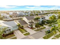 Stunning aerial view of a home in a waterfront community with palm trees and well manicured lawns at 422 Islebay Dr, Apollo Beach, FL 33572