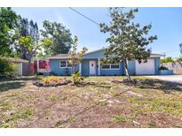 Charming single-story home featuring a manicured lawn and a quaint front yard with mature landscaping at 510 55Th Ne Ave, St Petersburg, FL 33703