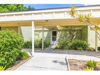 Inviting covered entrance with lush landscaping and a well-maintained walkway leading to the front door at 13512 Palmwood Ln # 13512, Tampa, FL 33618