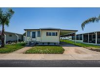 Charming single-story home with carport and well-maintained front yard at 144 Melody Ln, Tarpon Springs, FL 34689