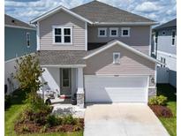 Charming two-story home featuring a manicured lawn, neutral siding, stone accents and a spacious two-car garage at 28847 Orange Berry Dr, Wesley Chapel, FL 33543