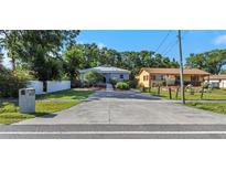 Charming single-story home featuring a long driveway, well-maintained lawn, and welcoming curb appeal at 403 Saint Petersburg W Dr, Oldsmar, FL 34677