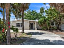 Charming single-story home with tropical landscaping and a well-manicured front yard, perfect for curb appeal at 4790 Shore Acres Ne Blvd, St Petersburg, FL 33703