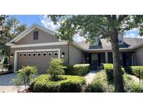 Charming single-Gathering home with a manicured lawn and two car garage under a blue sky at 5221 Bannister Park Ln, Lithia, FL 33547