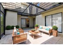 Inviting outdoor patio with stylish wicker furniture, covered with a glass roof and natural light at 12736 Wood Trail Blvd, Tampa, FL 33625