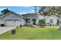 Charming single-story home with well-maintained landscaping and inviting curb appeal on a sunny day at 3004 Spring Hammock Dr, Plant City, FL 33566