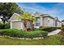 Charming single-story home featuring mature landscaping and a two-car garage at 3726 Rain Tree Ct, Palm Harbor, FL 34685
