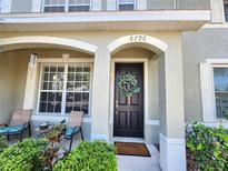 Charming front porch with seating, a decorative wreath, and a welcoming front door at 8796 Christie Dr, Largo, FL 33771