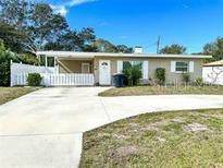 Charming single-story home featuring a well-maintained front yard and a classic white picket fence at 1228 Pineview Ave, Clearwater, FL 33756