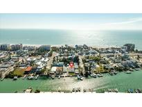 Aerial view of canal-front homes near a stunning beach, perfect for boating and coastal living at 12412 Lagoon Ln, Treasure Island, FL 33706