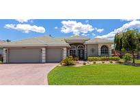 Charming single-story home with a well-manicured lawn, tile roof, and a two-car garage at 2875 Grazeland Dr, Sarasota, FL 34240