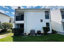 Well-maintained townhouse exterior with manicured lawn and visible unit numbers at 631 Haven Pl, Tarpon Springs, FL 34689