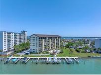 Waterfront condominium building featuring private boat slips and well maintained grounds at 650 Island Way # 204, Clearwater Beach, FL 33767