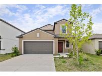 Charming two-story home features a two-car garage and well-maintained landscaping at 7205 Ronnie Gardens Ct, Tampa, FL 33619