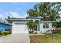 Charming single-Gathering home featuring a garage and well-maintained front yard, perfect for curb appeal at 8605 N Taliaferro Ave, Tampa, FL 33604