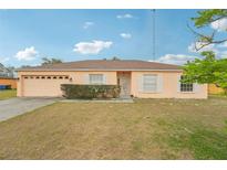 Charming single-story home features a well-maintained front yard and a classic exterior design at 12124 Colonial Estates Ln, Riverview, FL 33579