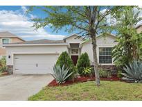 Charming single-story home with well-maintained landscaping and a two-car garage at 304 Shell Manor Dr, Ruskin, FL 33570