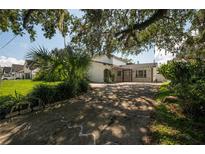 Charming single-Gathering home with mature landscaping and a spacious driveway at 3212 W Arch St, Tampa, FL 33607