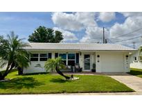 Charming single-story home with well-maintained lawn and a quaint front patio at 3890 Mainlands N Blvd, Pinellas Park, FL 33782