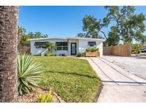 Charming single-story home with a well-manicured lawn and concrete driveway at 4001 W North A St, Tampa, FL 33609