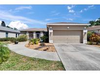 Charming single-story home featuring a two-car garage, neutral stucco, landscaped yard and inviting walkway to the front door at 4017 3Rd E Ave, Bradenton, FL 34208