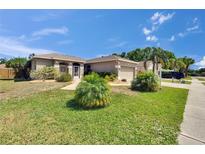 Well-manicured lawn, mature shrubbery, and palm trees enhance the curb appeal of this home at 4017 3Rd E Ave, Bradenton, FL 34208