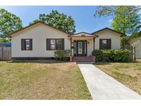 Charming single Gathering home with tan siding, black shutters, and a walkway leading to the front door at 4410 19Th N St, St Petersburg, FL 33714