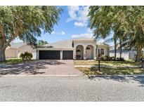 Charming home featuring a spacious three car garage and a brick paved driveway at 4809 Walnut Ridge Rd, Land O Lakes, FL 34638