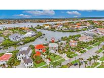 Stunning aerial view of waterfront home showcasing its prime location and gorgeous surrounding community at 6301 Marbella Blvd, Apollo Beach, FL 33572