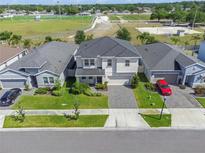 Beautiful two-story home with a well-manicured lawn, paver driveway and sidewalk in a desirable neighborhood at 10814 Whitland Grove Dr, Riverview, FL 33578