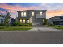 Charming two-story home with a well-maintained front lawn and inviting curb appeal at 10814 Whitland Grove Dr, Riverview, FL 33578