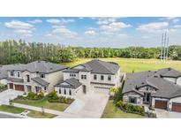 Beautiful two-story home with a well-manicured lawn and attached two car garage in a modern community at 14507 Woodland Spur Dr, Lithia, FL 33547