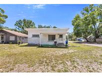 Charming single-story home with a flat roof, quaint porch, and lawn at 1778 27Th N Ave, St Petersburg, FL 33713