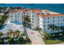 Stunning waterfront condominium with manicured landscaping, beautiful water views, and a red-tiled roof at 1860 N Fort Harrison Ave # 106, Clearwater, FL 33755