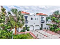 Stunning two-story townhouse featuring a red tile roof, a balcony, and a well-manicured front yard at 406 S Melville Ave # 1, Tampa, FL 33606