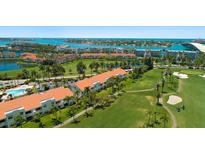 Beautiful aerial view of resort condos with golf course, tropical landscaping, and waterfront views at 6191 Bahia Del Mar Blvd # 204, St Petersburg, FL 33715