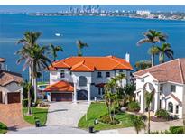 Stunning waterfront home with tile roof, lush landscaping, and views of the bay and city skyline at 1901 Carolina Ne Ave, St Petersburg, FL 33703