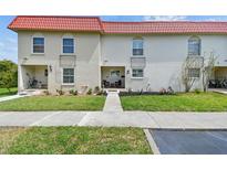 Charming condo building with a red tile roof and well-maintained landscaping in a desirable neighborhood at 2700 Bayshore Blvd # 522, Dunedin, FL 34698