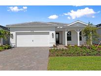 Charming one-story home with a two-car garage and beautifully landscaped front yard at 29156 Coral Harbour Dr, Englewood, FL 34223