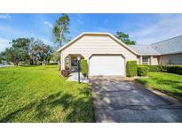Charming single-story home featuring a well-manicured lawn, attached garage, and welcoming curb appeal at 4819 Boonesboro Ct, New Port Richey, FL 34655