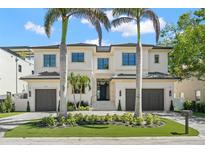Elegant two-story home featuring a manicured lawn, two-car garage and a beautiful exterior with a symmetrical design at 5142 W San Jose St, Tampa, FL 33629