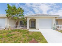 Inviting single-story home with a well-maintained lawn, driveway, and attached garage at 5421 Orange Blossom N Rd, Pinellas Park, FL 33782