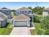 Charming two-story home featuring a two-car garage, neutral paint, and well-manicured lawn at 7207 Forest Mere Dr, Riverview, FL 33578