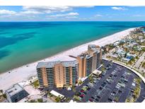 Stunning aerial view of oceanfront condo, beach, and parking with bright blue ocean backdrop at 880 Mandalay Ave # N710, Clearwater Beach, FL 33767