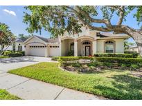 Charming one-story home with a well-manicured lawn, mature landscaping, and a spacious three-car garage at 10510 Castleford Way, Tampa, FL 33626
